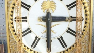 A dial, inlaid in gold, of the Royal Clock is being raised into position in Makkah.